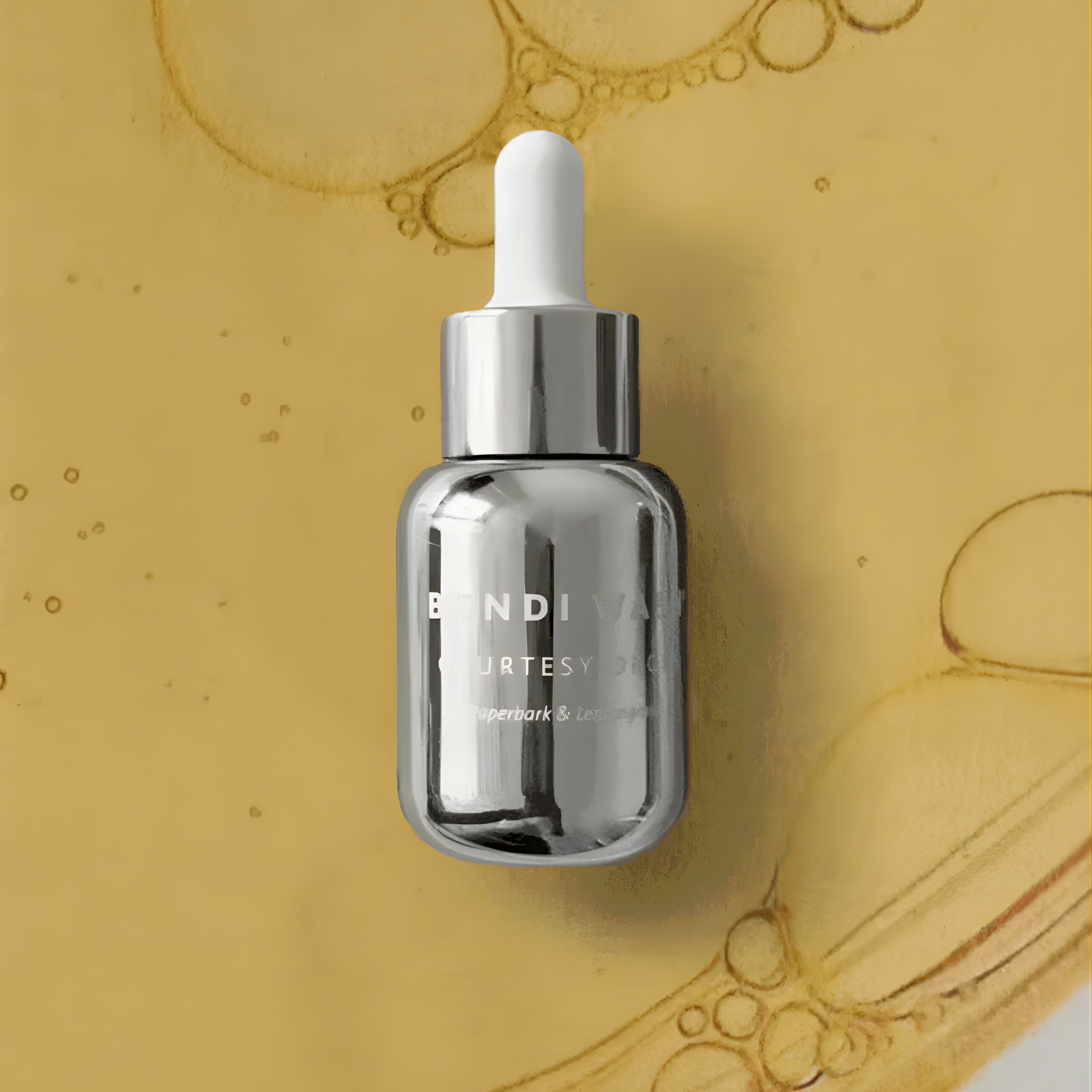 Bondi Wash Courtesy Drops air freshener bottle with dropper, featuring a sleek design and natural scent elements.