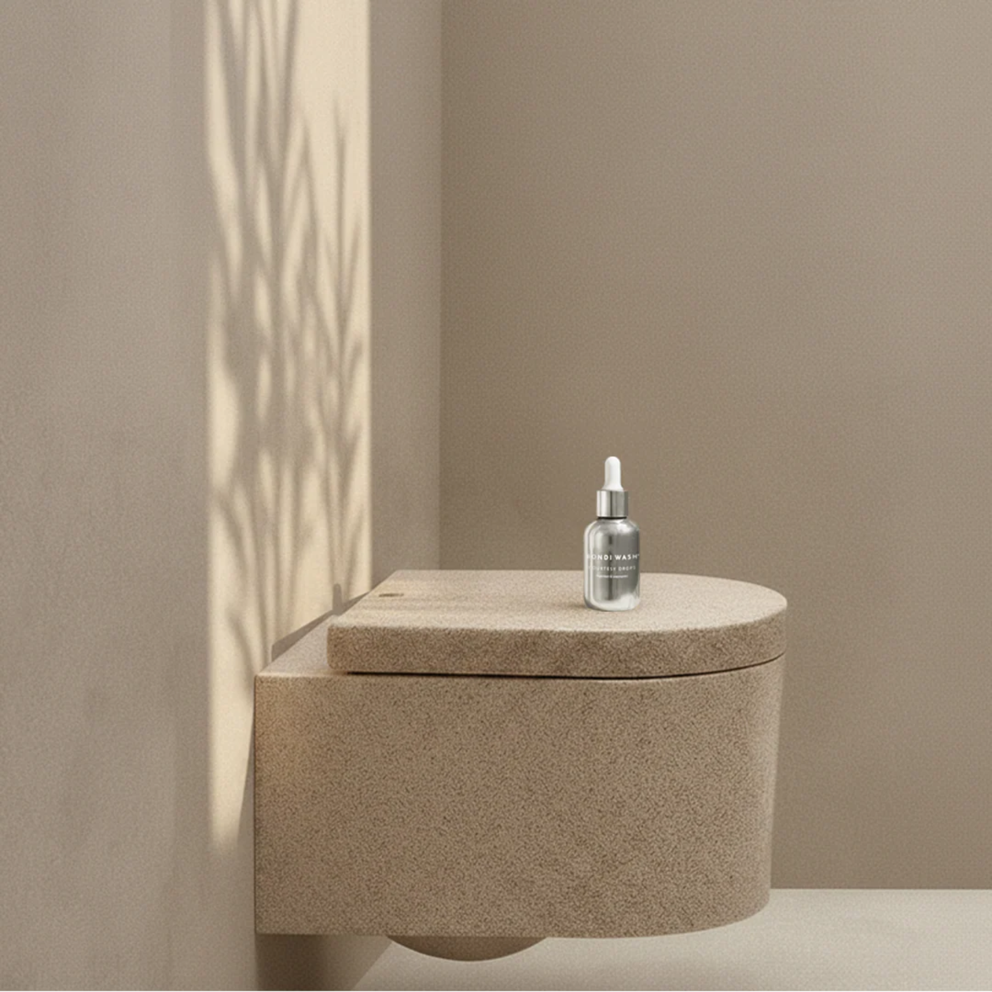 Bondi Wash Courtesy Drops air freshener with a sleek white bottle and dropper cap, designed to freshen and scent indoor spaces.