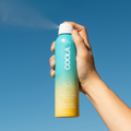 Coola Classic Body Organic Sunscreen Spray SPF30 with Pina Colada scent, featuring a spray bottle and tropical-themed design.
