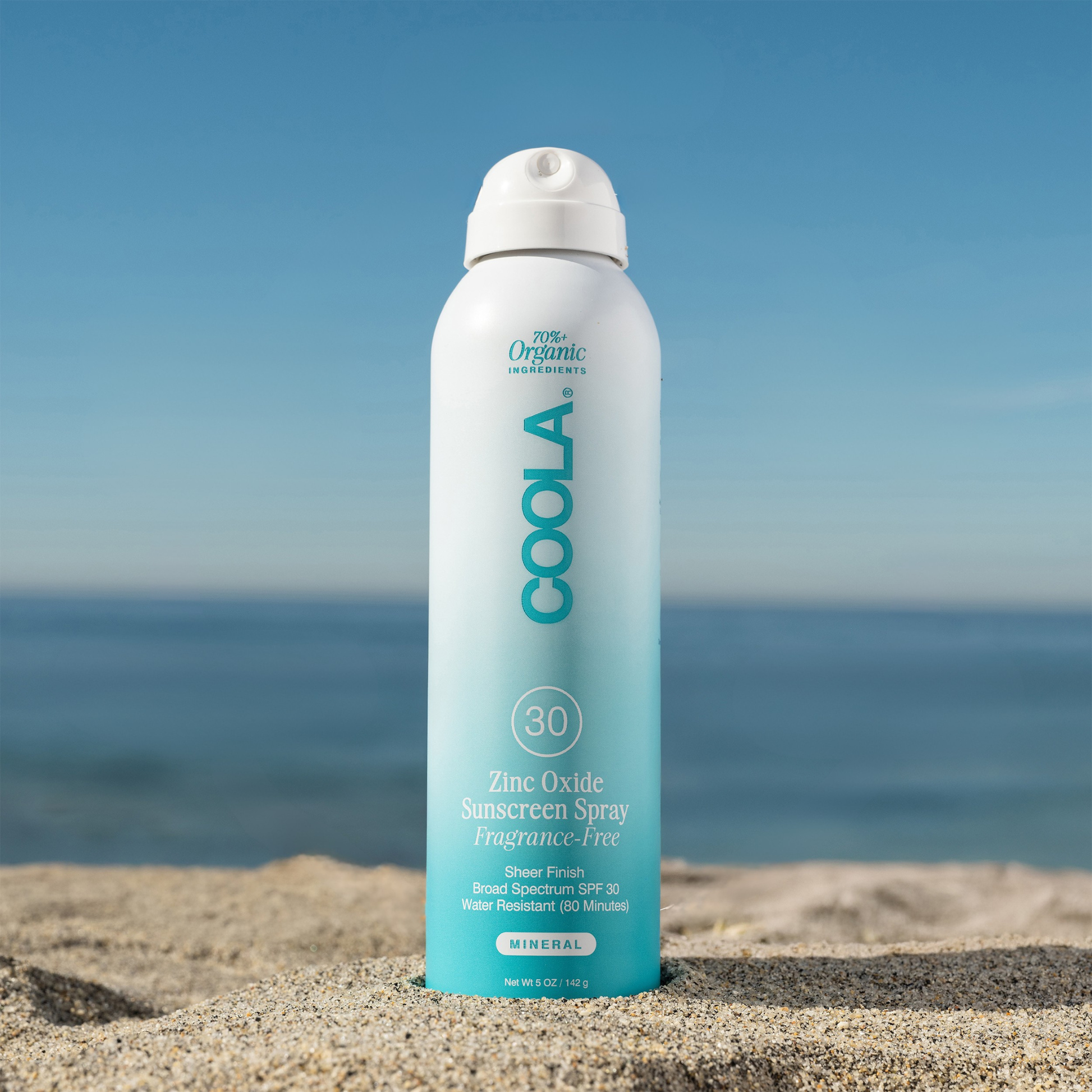 Coola Zinc Oxide Sunscreen Spray SPF30, fragrance-free, in a spray bottle with a white cap, designed for sun protection.