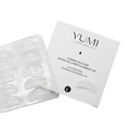 Yumi Lashes & Brows silicone adhesive pads and reusable adhesive cups in a clear plastic tray, shown next to their white product packaging box. Labeled size L.