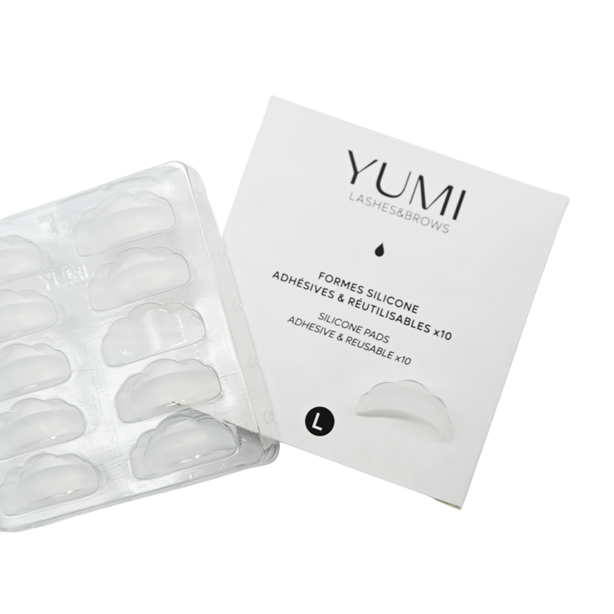 Yumi Lashes & Brows silicone adhesive pads and reusable adhesive cups in a clear plastic tray, shown next to their white product packaging box. Labeled size L.
