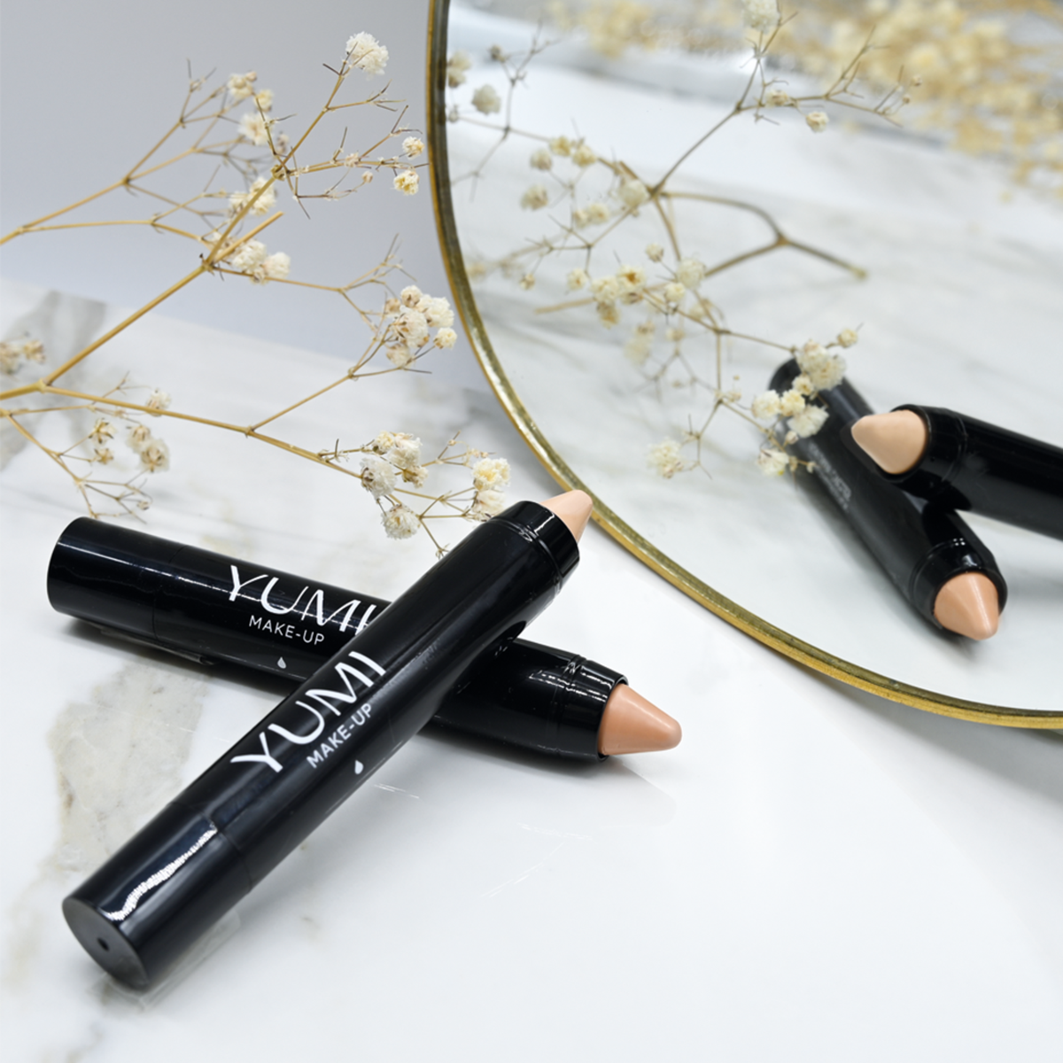 Yumi Beauty makeup concealer stick in light beige, shown in packaging