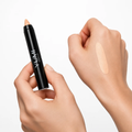 Yumi Beauty Makeup Concealer Stick in Medium Beige shade, angled view of the cosmetic tube and cap