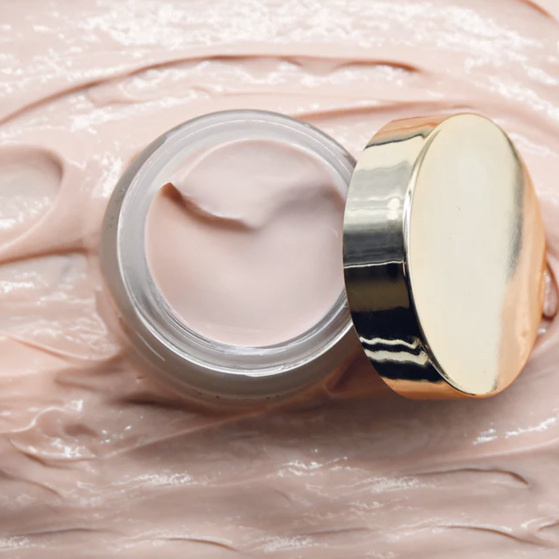 Yumi Skincare Glow Up Night Crea, in a  jar with gold lid on a tpink cream bottom