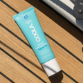 Fragrance-free Coola Classic Face Organic Sunscreen Lotion SPF50 in a white tube with a blue cap, shown on a plain background.