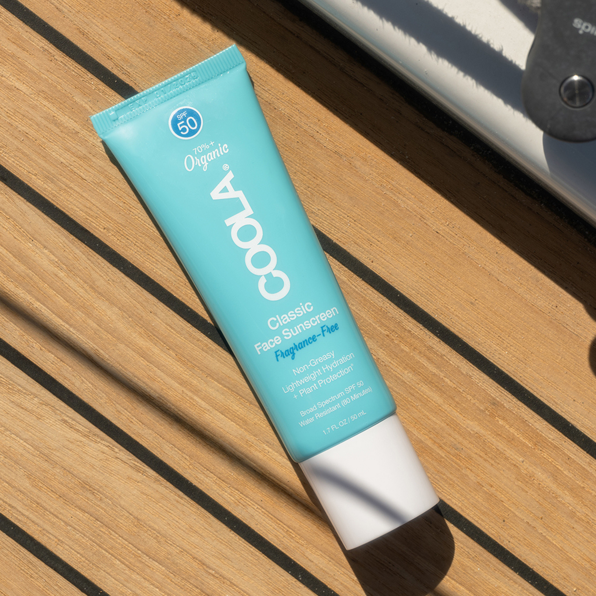 Fragrance-free Coola Classic Face Organic Sunscreen Lotion SPF50 in a white tube with a blue cap, shown on a plain background.