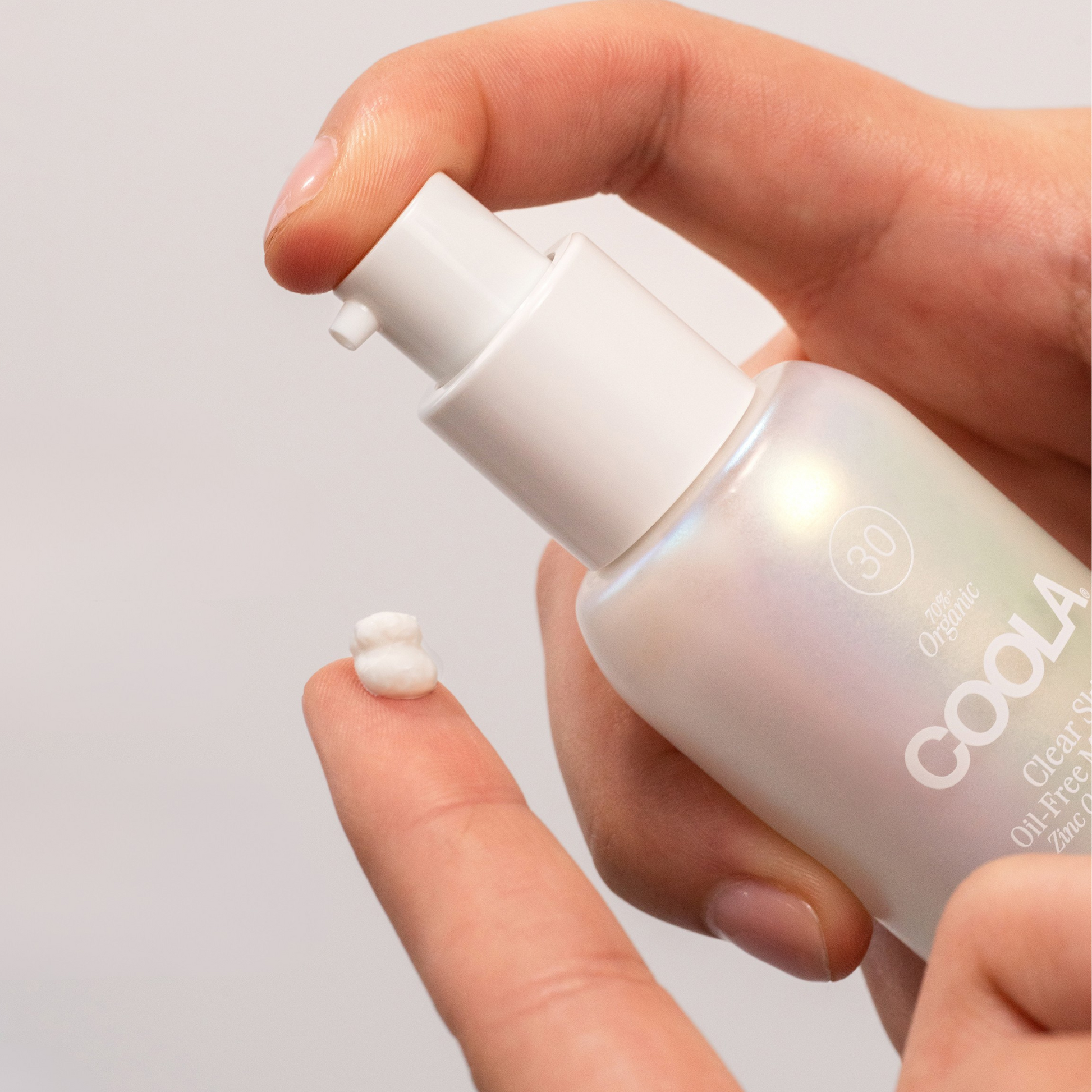 Coola Clear Skin Zinc Oxide Sunscreen SPF30 in a skincare serum bottle with a pump dispenser, designed for face protection.