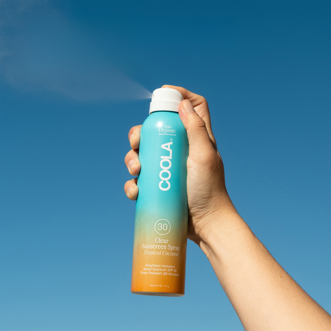 Coola Clear Sunscreen Spray SPF30 with tropical coconut scent in a transparent spray bottle.