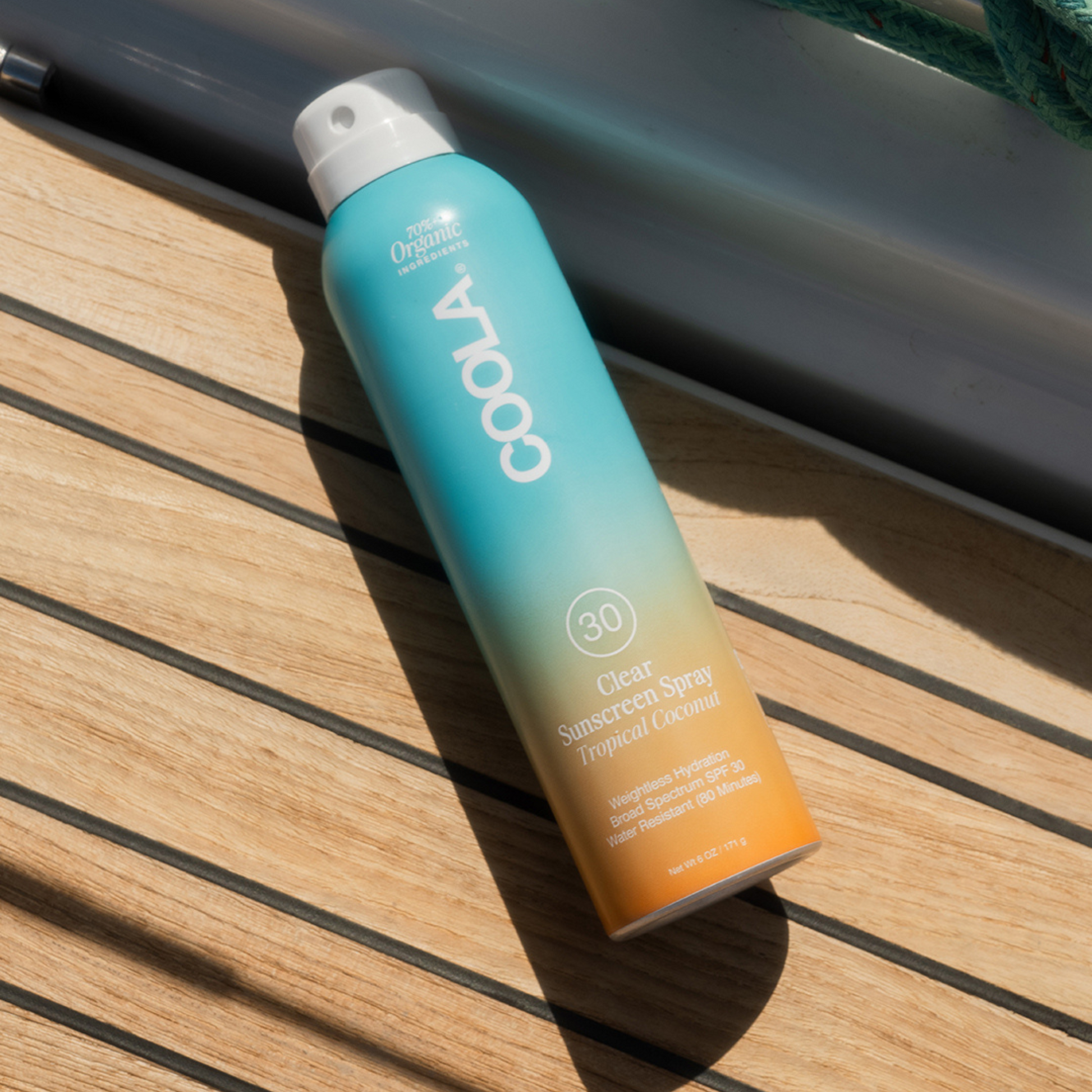 Coola Clear Sunscreen Spray SPF30 with tropical coconut scent, lightweight spray bottle for face and body sun protection.