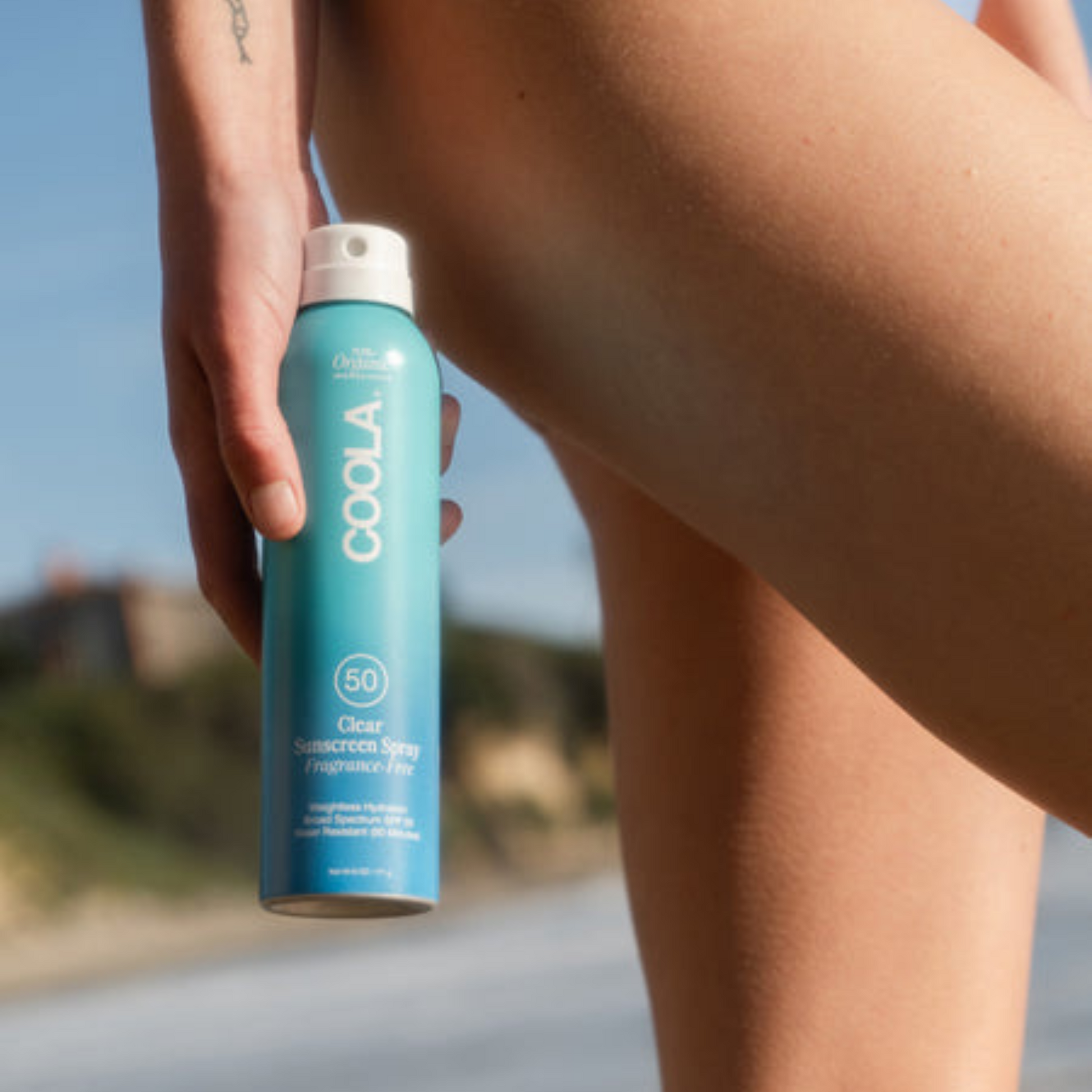 Coola Clear Sunscreen Spray SPF50 by Coola Suncare, fragrance-free, with transparent application visible in the image.