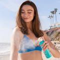 Coola Clear Sunscreen Spray SPF50 with Guava Mango scent, showing a transparent spray bottle with vibrant mango and guava fruit images.