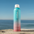 Coola Suncare Clear Sunscreen Spray SPF50 with Guava Mango scent, showing the transparent spray bottle and vibrant fruit design.