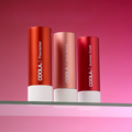 Coola Suncare Organic Tinted Mineral Lip Sunscreen Trio SPF30 with three tinted lip balms in sleek packaging.