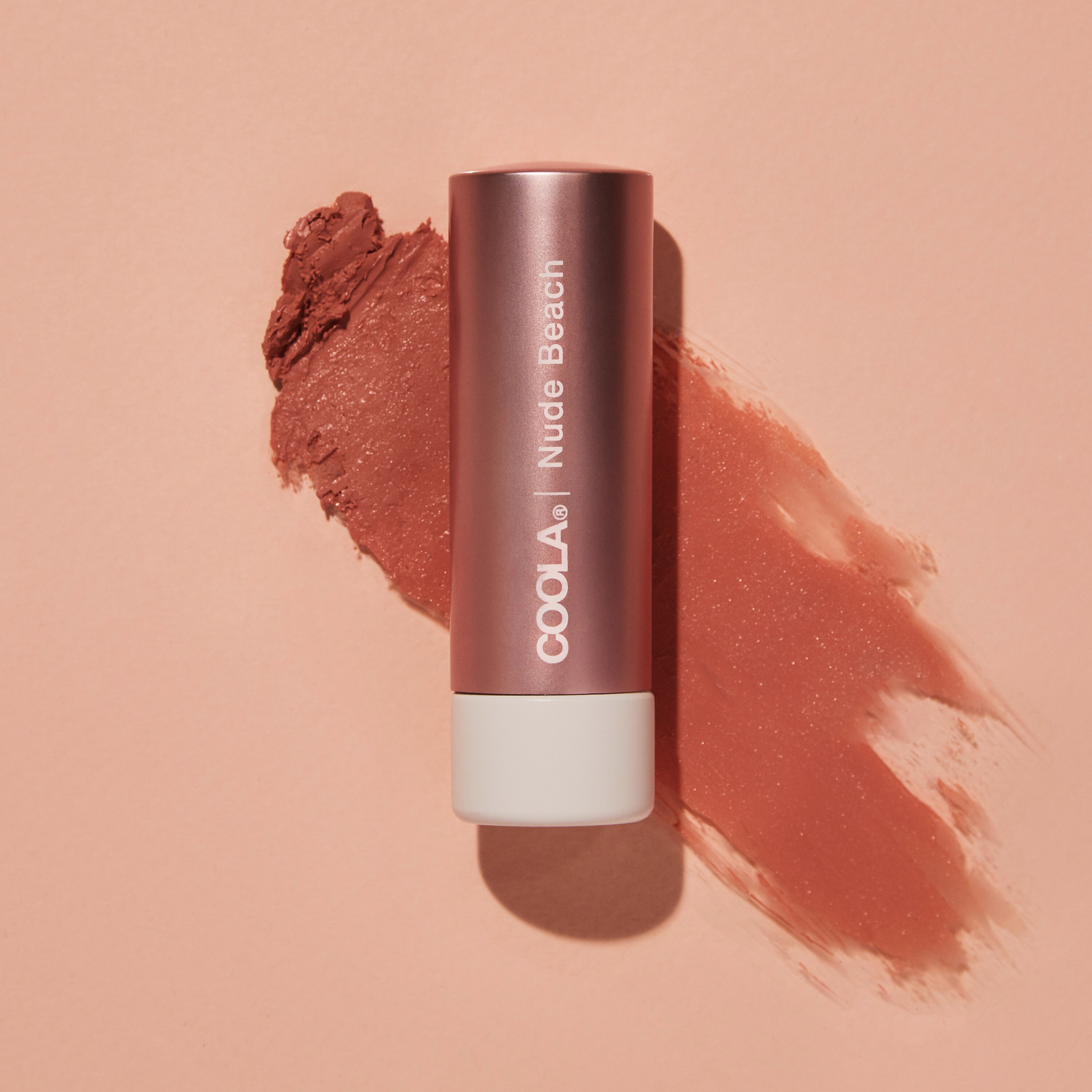 Coola Mineral Liplux Organic Tinted Lip Balm with SPF 30 in Nude Beach shade, showing the smooth, tinted lip balm stick.