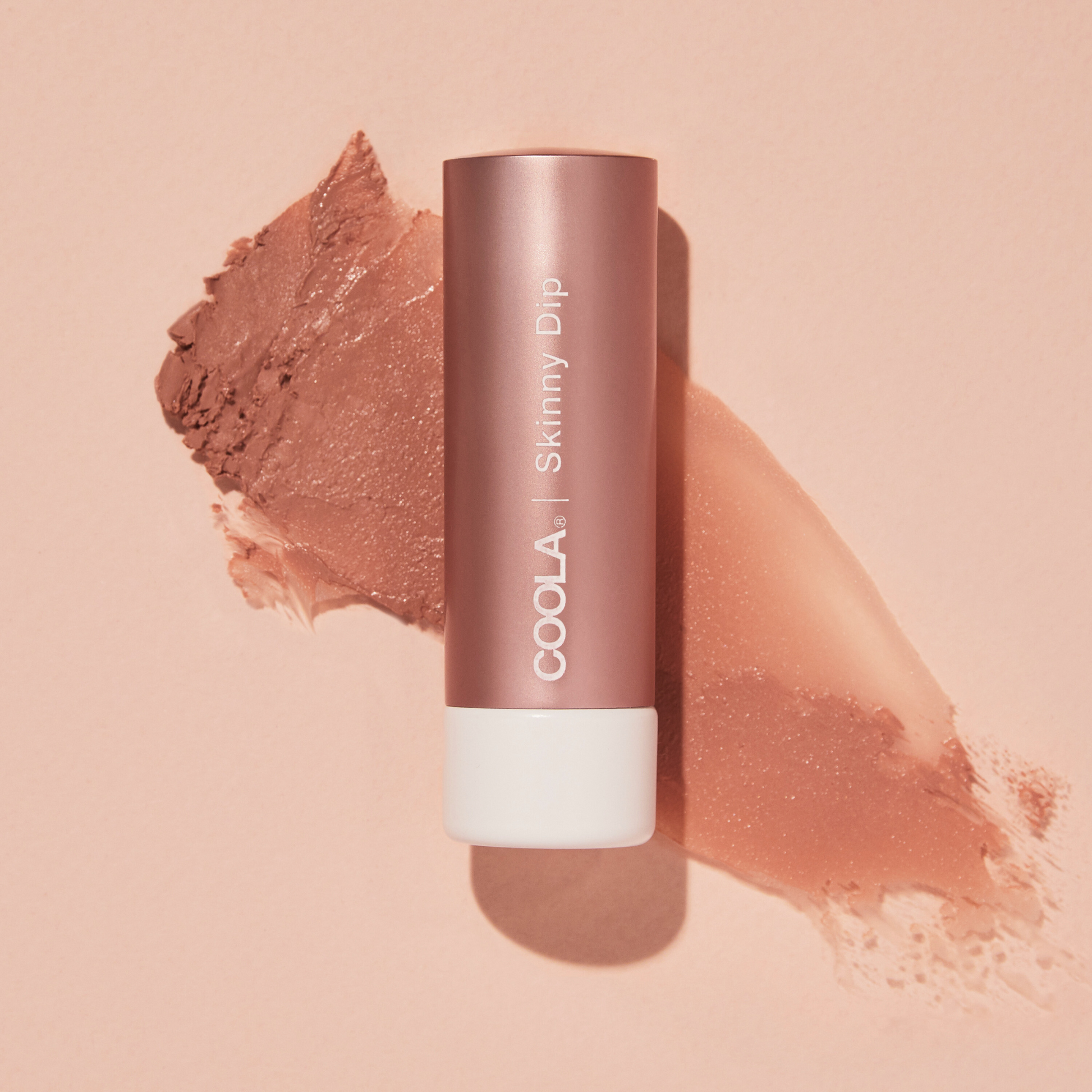 Coola Mineral Liplux Organic Tinted Lip Balm with SPF30 in Skinny Dip shade, showing the colorful tube and natural packaging.