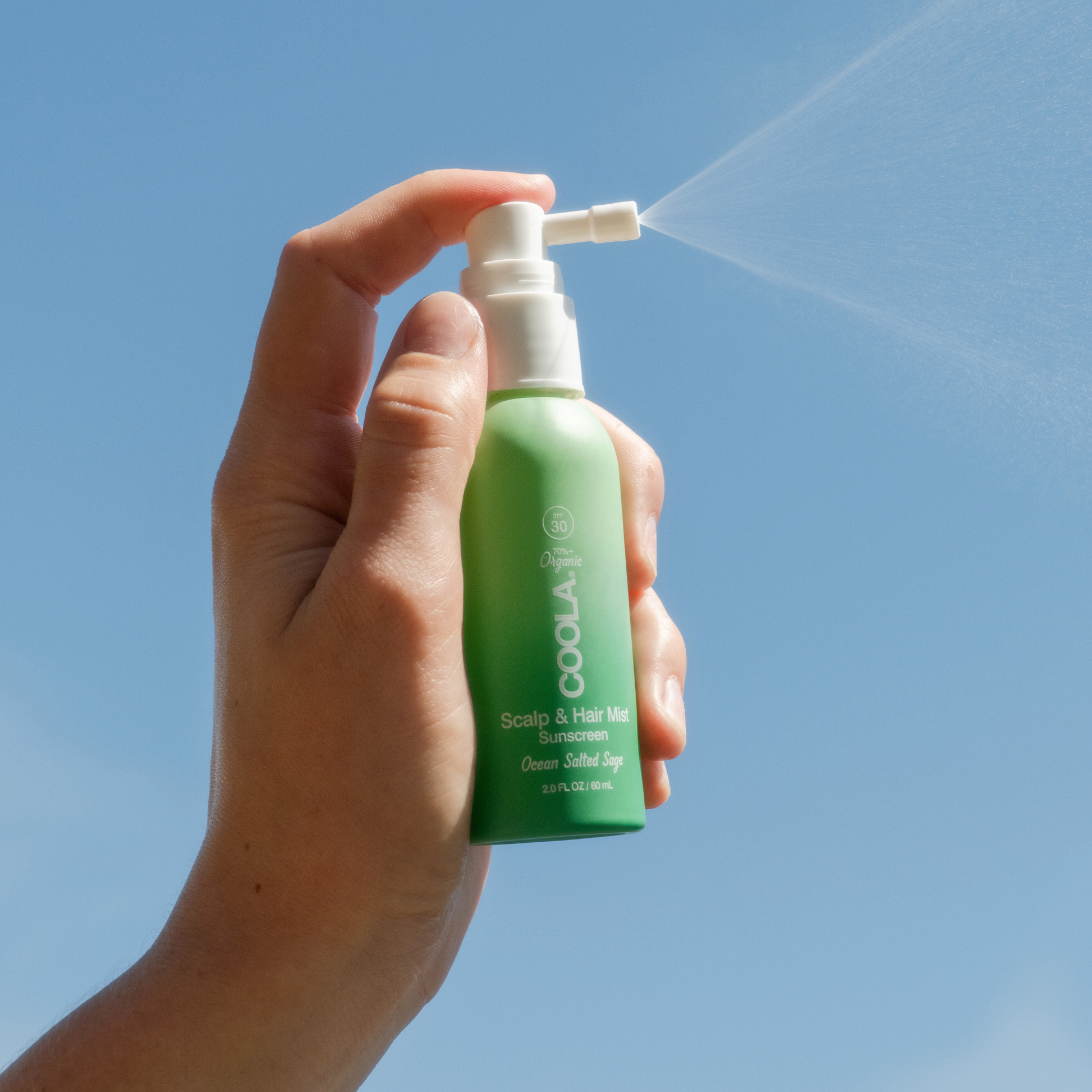 Coola Suncare organic SPF 30 scalp and hair mist spray bottle, designed to protect hair and scalp from sun damage.