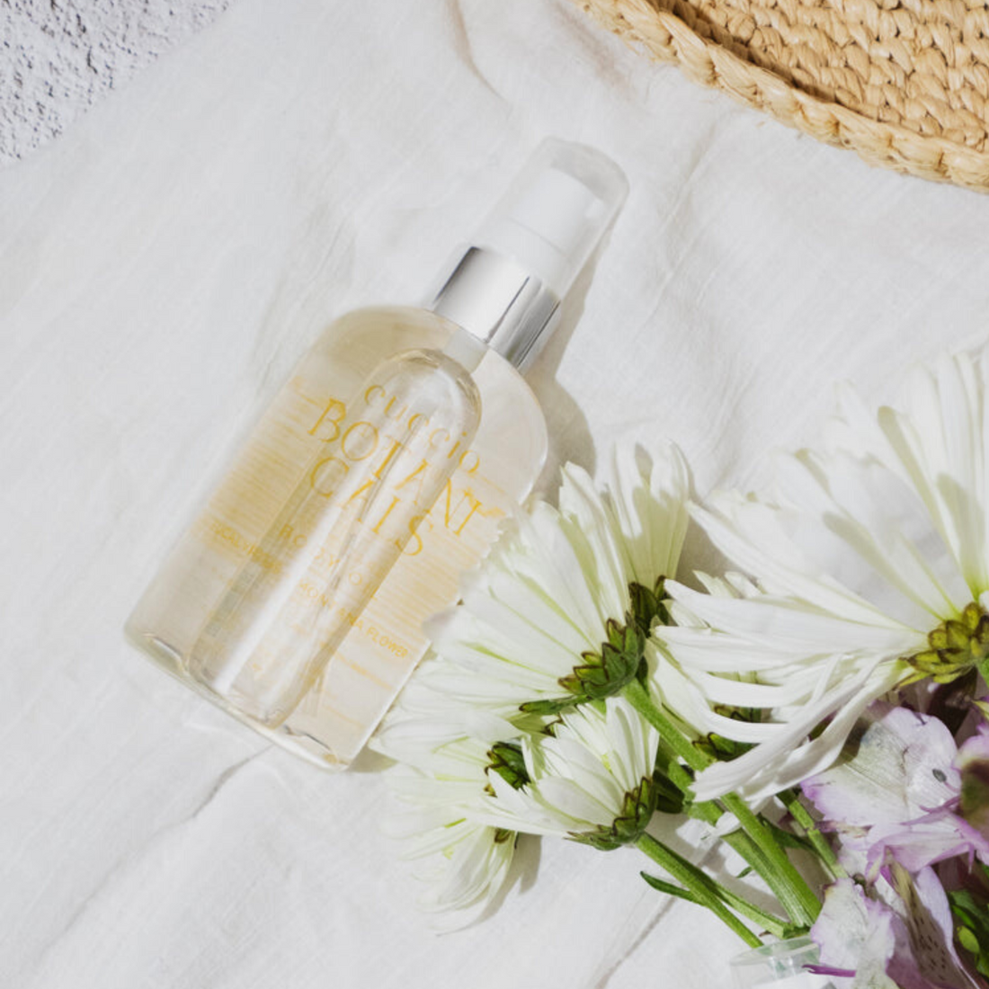 Cuccio Botanicals eucalyptus and Montana flower body oil bottle with botanical label and clear glass container.