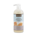 Cuccio Naturalé Milk & Honey Body Wash showing a 946ml bottle with creamy liquid and honey accents.