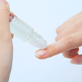 Cuccio Naturalé Amalfi Garden revitalizing cuticle oil roll-on applied to fingernail cuticles, featuring botanical ingredients.
