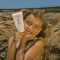 Eco by Sonya Driver Glory Veil Sunscreen Lotion SPF50+ in a white tube with a blue cap, designed for sun protection and skin care.