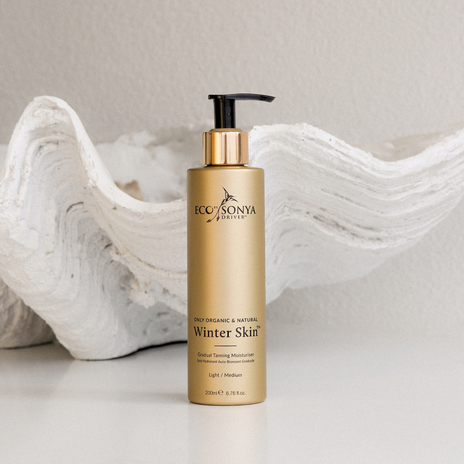 Eco by Sonya Driver Winter Skin self-tanner bottle with tan applicator, showcasing the product packaging for winter skin glow.