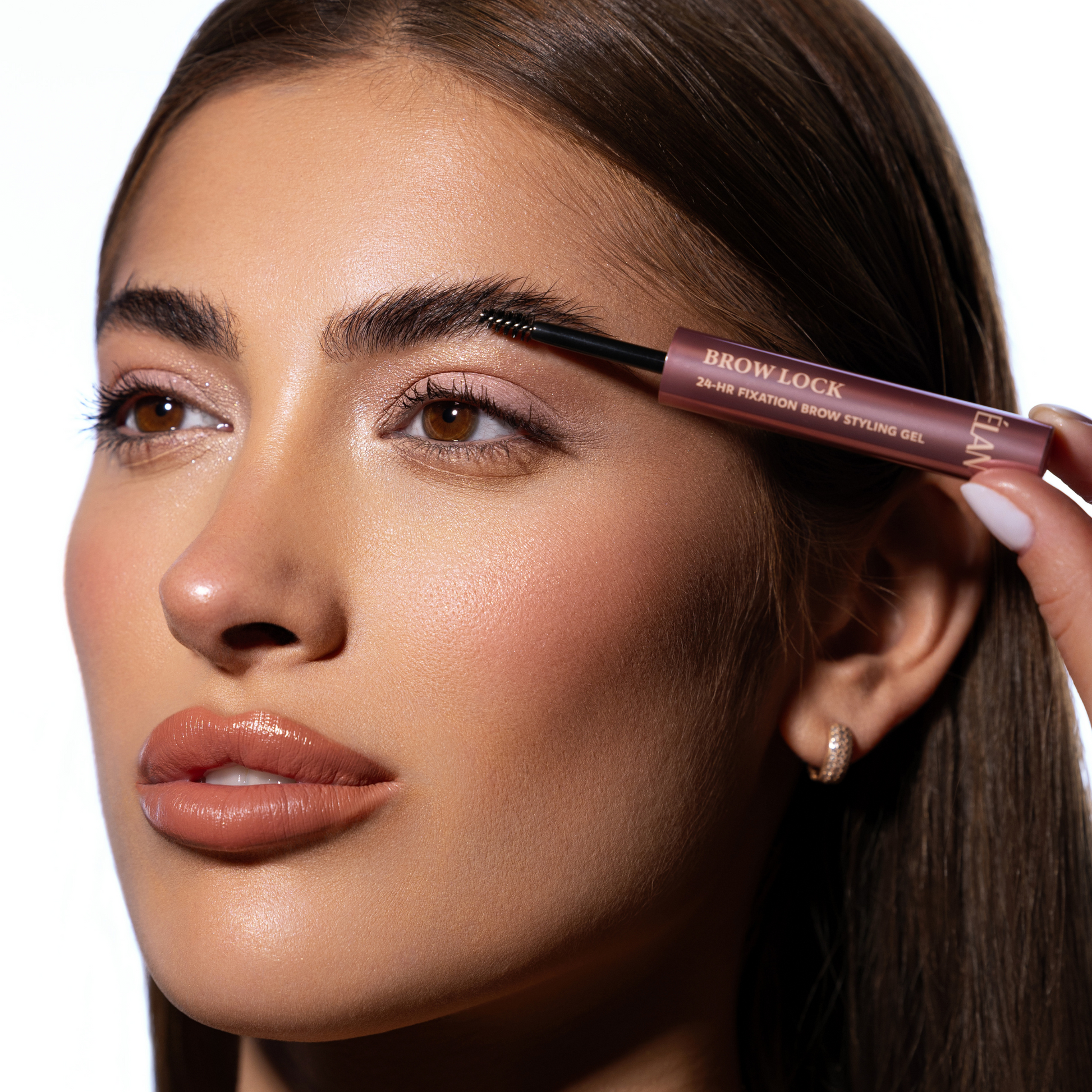 Élan Brow Lock strong fixation brow styling gel in a clear tube, designed for shaping and setting eyebrows.