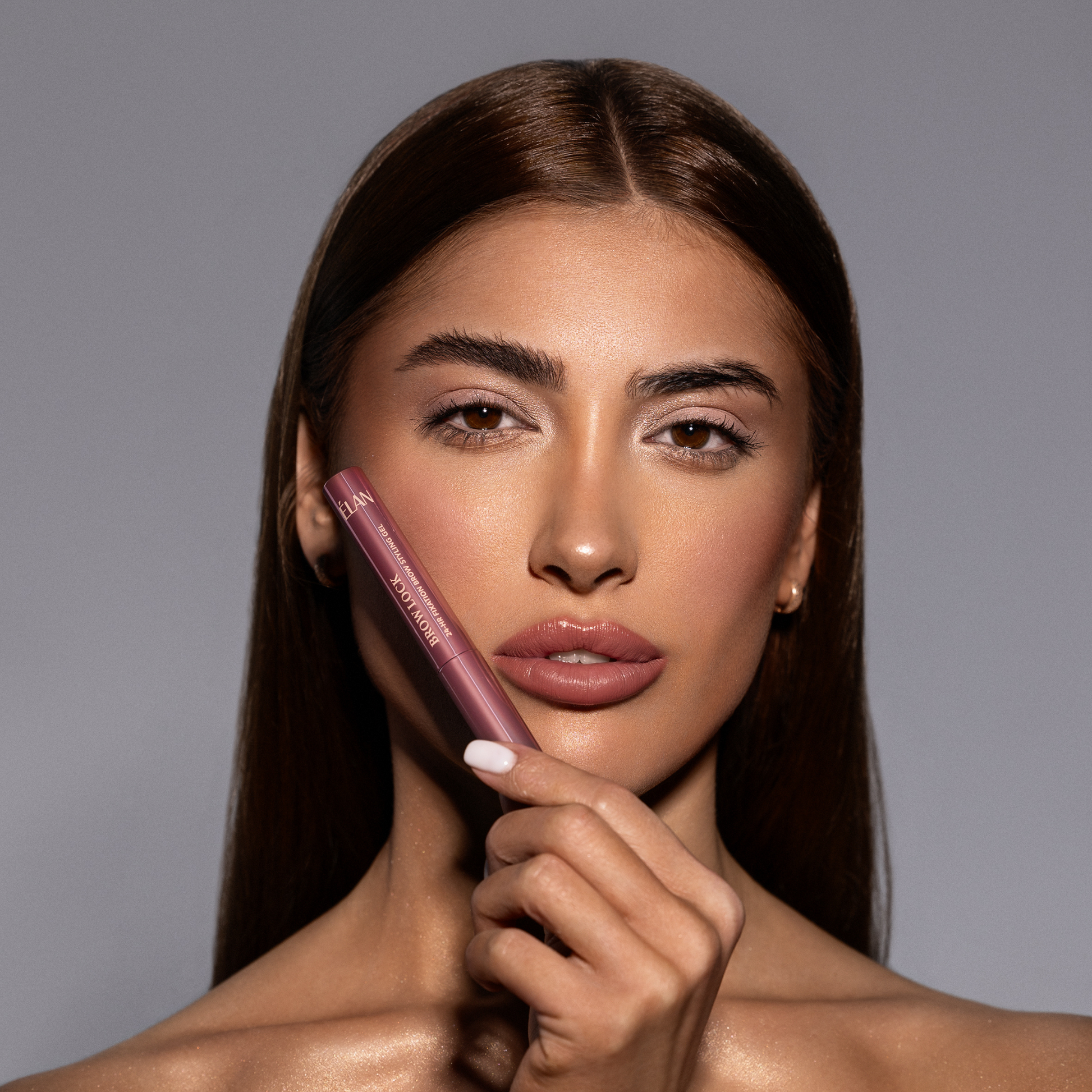 Élan Brow Lock strong fixation brow styling gel in a clear tube, designed for shaping and setting eyebrows.