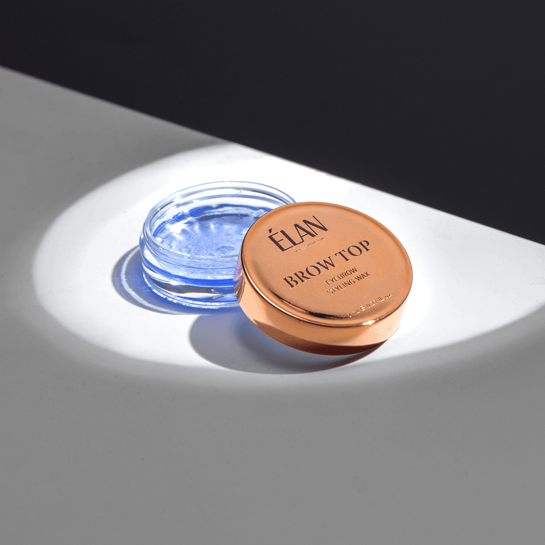 Élan Brow Top eyebrow styling wax in a compact container for brow shaping and fixing, part of Élan Cosmetics lashes and brows aftercare.