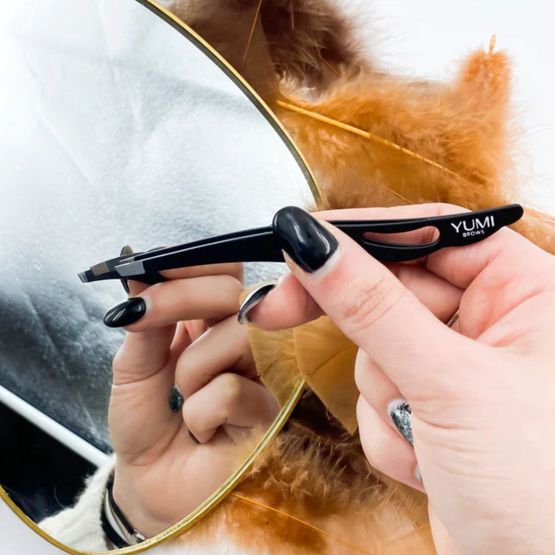 Black Yumi Brows Tweezer with slant tip, ideal for precise eyebrow grooming and shaping, from Yumi Lashes.