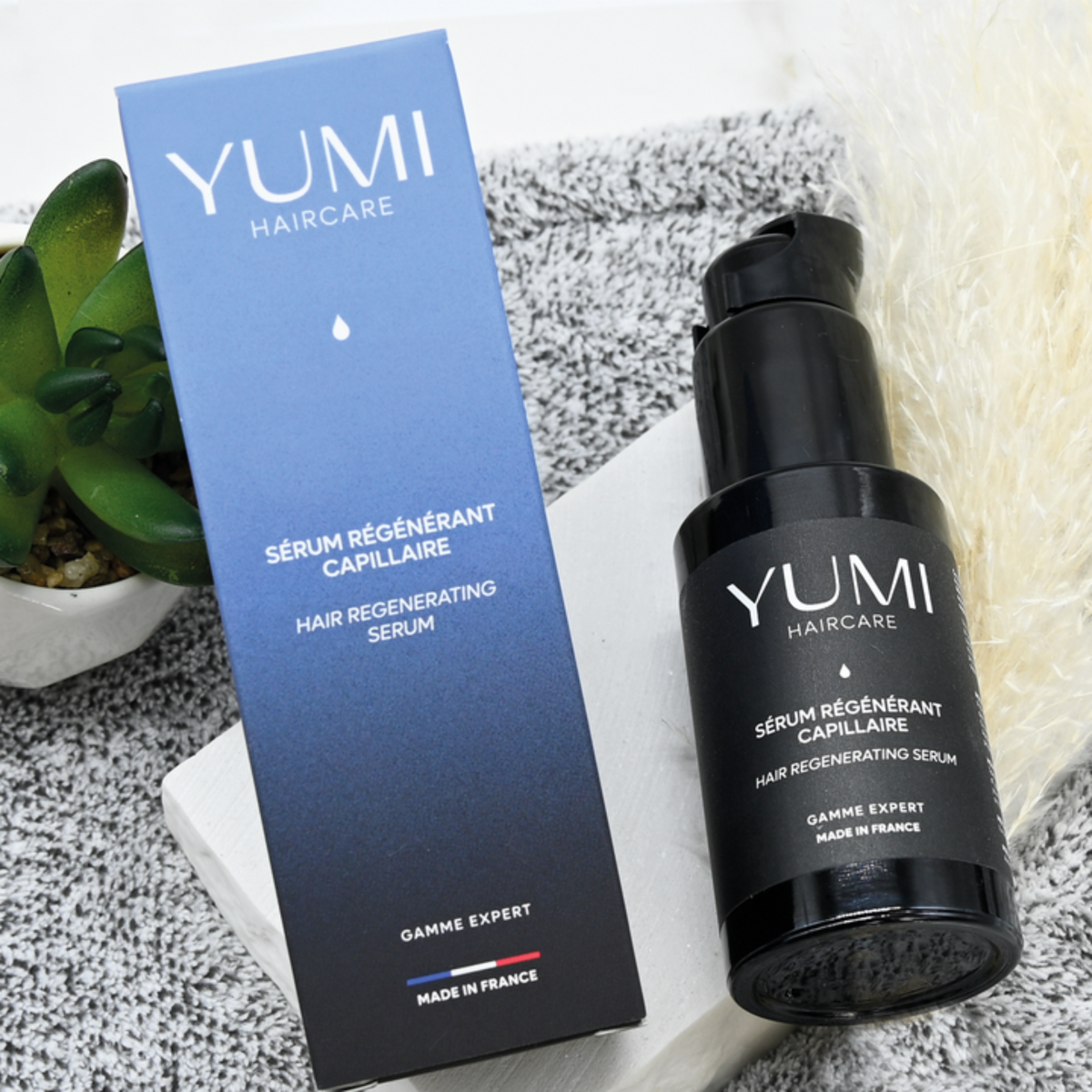 Yumi Haircare Hair Regenerating Serum bottle with applicator tip, designed to promote hair growth and improve hair health.