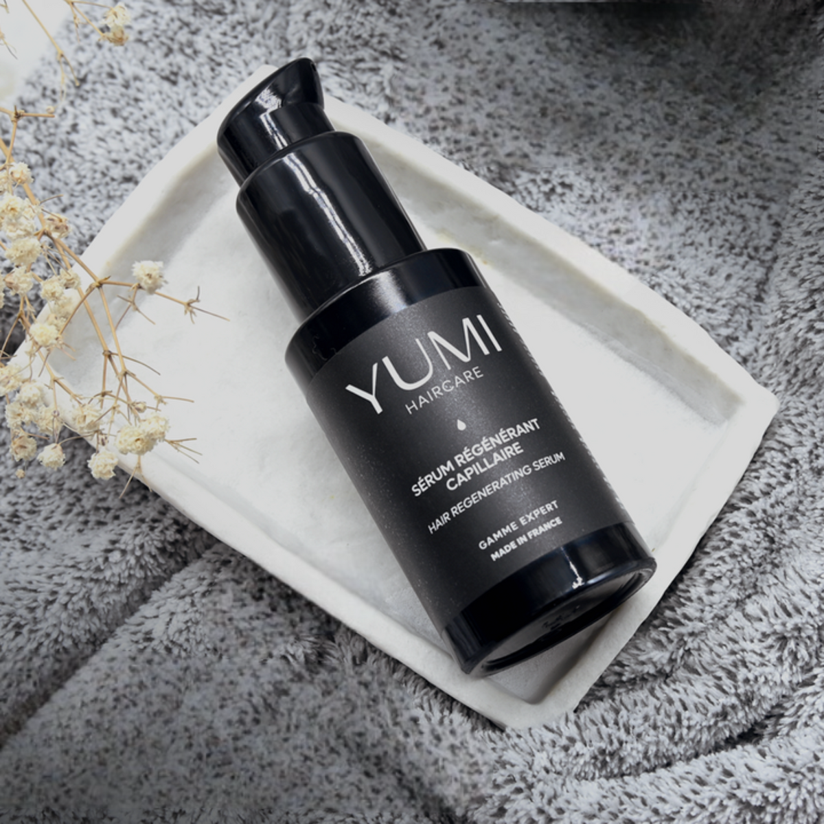 Yumi Haircare Hair Regenerating Serum bottle with dropper, designed to promote hair growth and repair damaged hair.