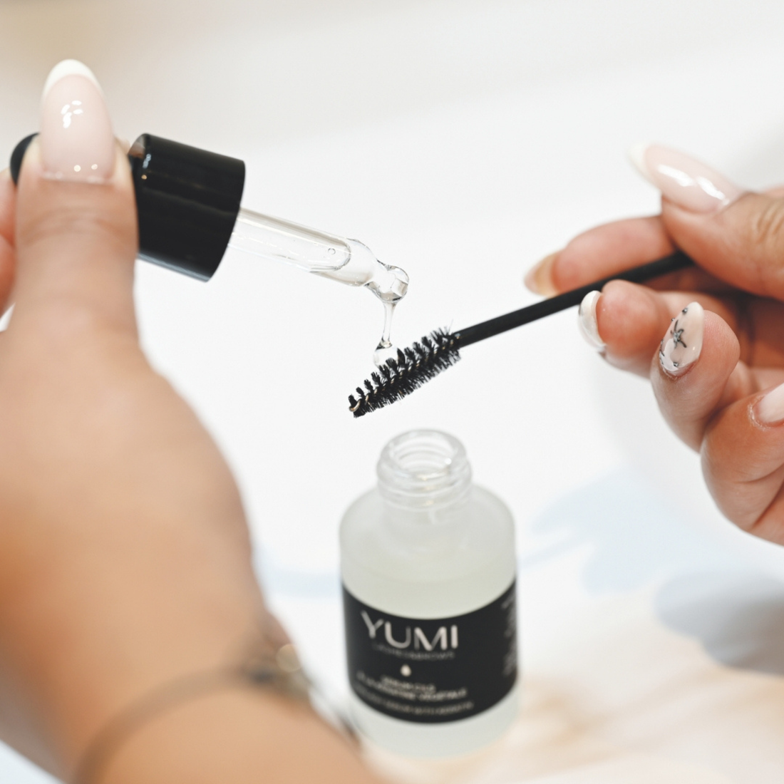 Yumi Lashes & Brow eyelash serum with keratin in a sleek bottle, designed to enhance lash and brow growth naturally