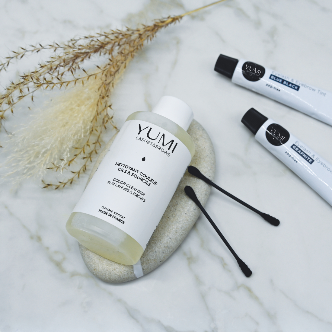 Yumi Lashes & Brows Color Cleanser for lashes and eyebrows, in a sleek bottle, used for removing color from lashes and brows.