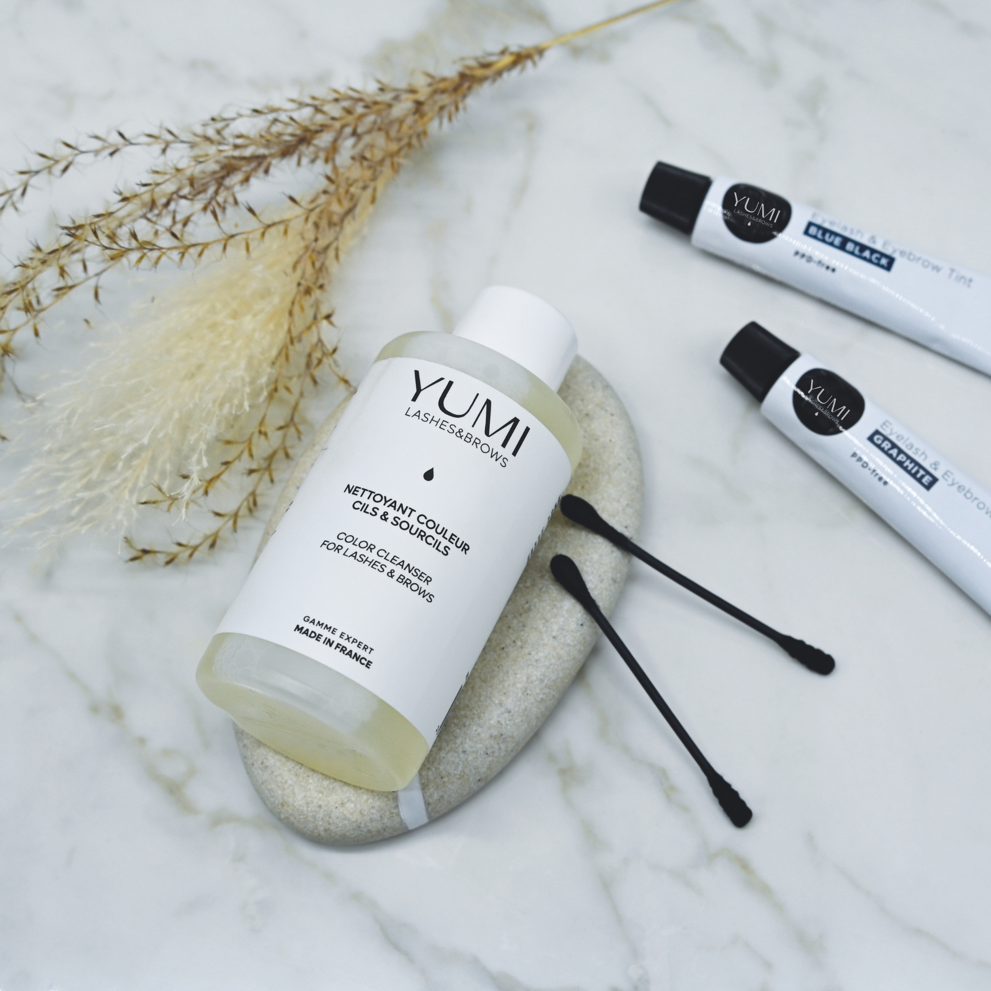 Yumi Lashes & Brows Color Cleanser for lashes and brows, clear bottle with product label, used for gentle color removal.