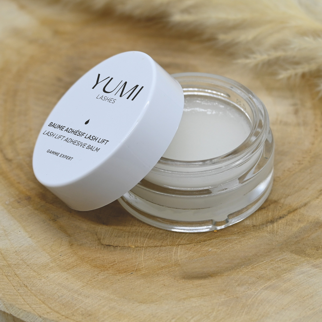 Yumi Lashes Lash Lift Adhesive Balm for lashes and brows, in a small jar with a clear lid, used for eyelash lift procedures.
