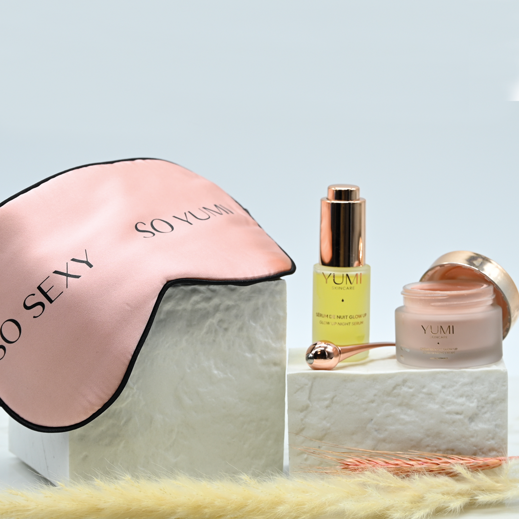 Cosmetic set with serum, cream, and tools in a box on a white background