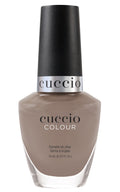 Cuccio Colour Loom Mates nail polishes in vibrant shades, arranged in a display with the Cuccio Colour branding visible.