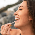Coola Classic Liplux Organic Hydrating Lip Oil Sunscreen SPF30 showing a sleek lip oil tube with SPF protection.