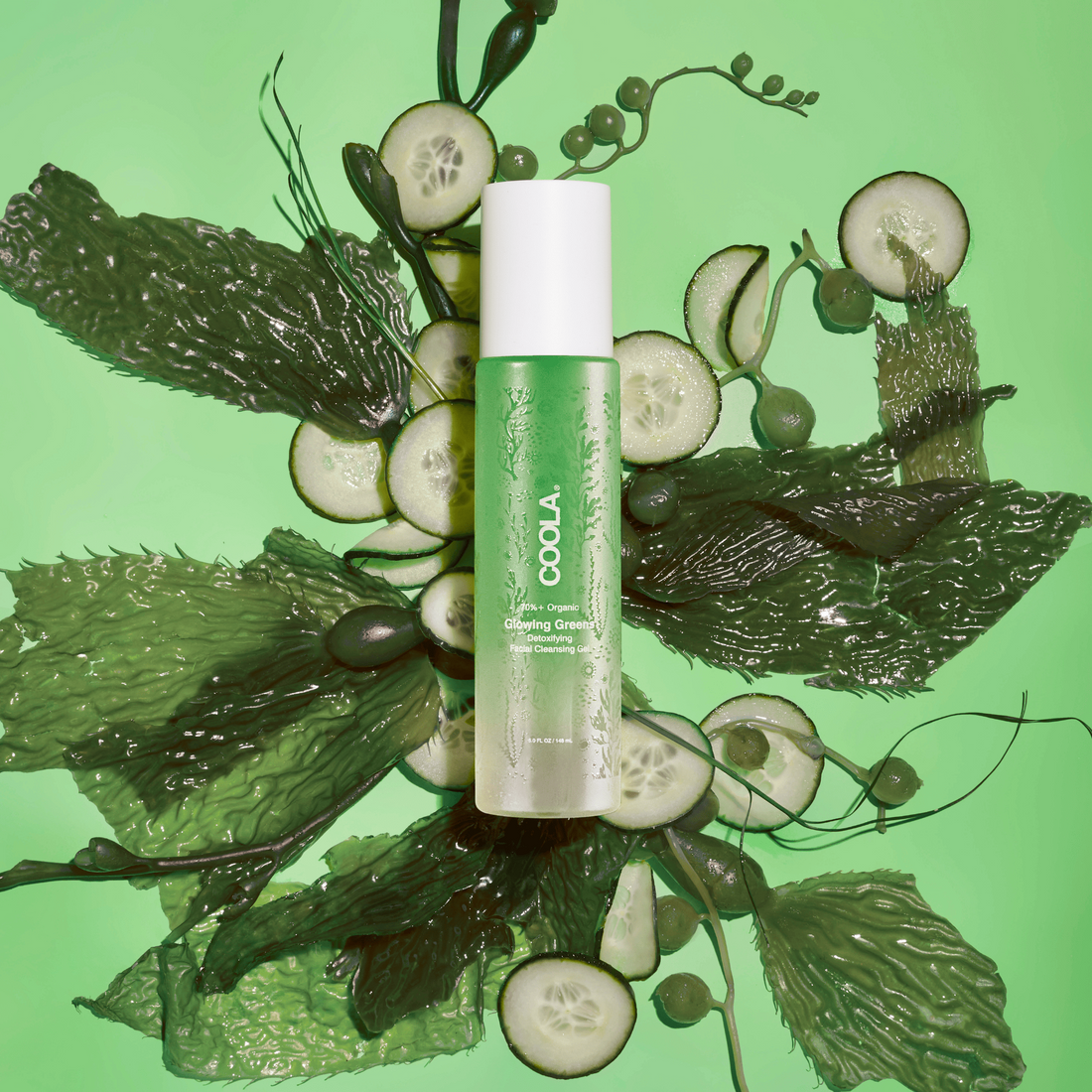 Coola Glowing Greens Detoxifying Facial Cleansing Gel from Coola Suncare, shown in a clear tube with green accents.