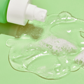 Coola Glowing Greens Detoxifying Facial Cleansing Gel in a sleek tube, designed for deep cleansing and refreshing skin.