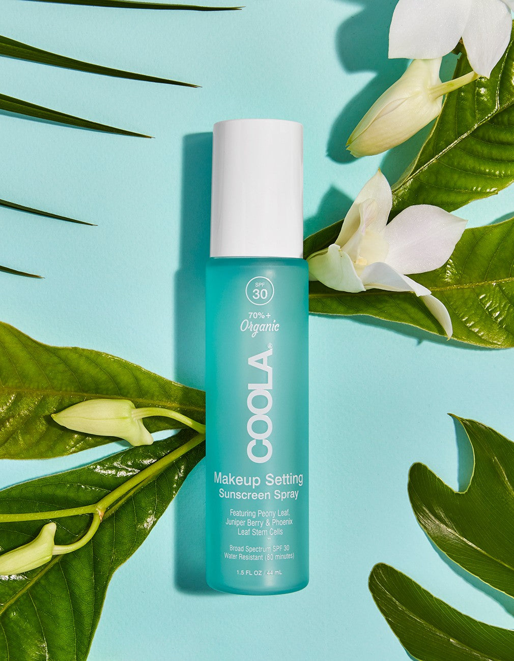 Coola Suncare organic SPF30 makeup setting spray with sun protection, featuring a clear spray bottle and fresh botanical design.