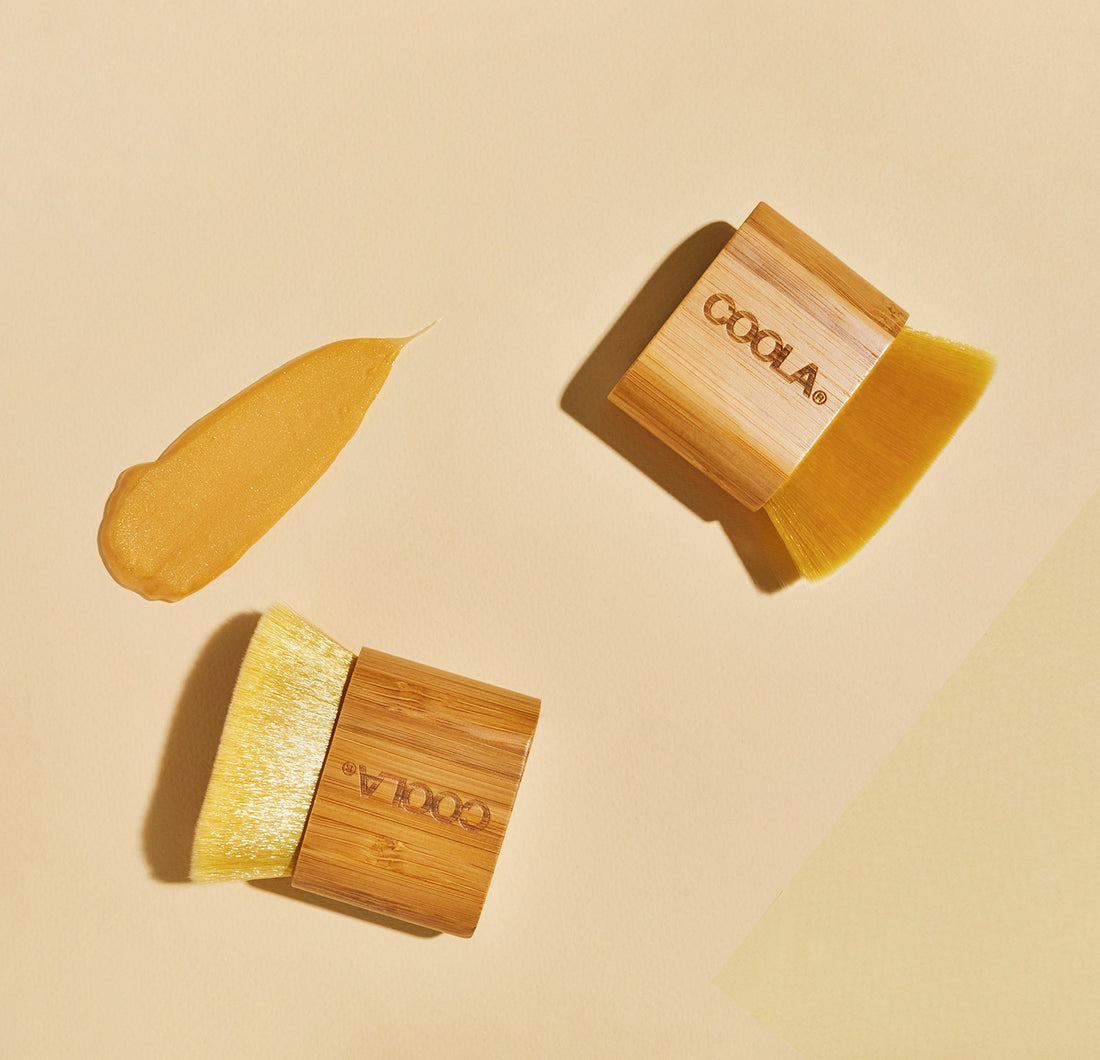 Coola Organic Sunless Tan Kabuki Body Brush for self-tanning, with soft bristles and ergonomic handle, ideal for even application.