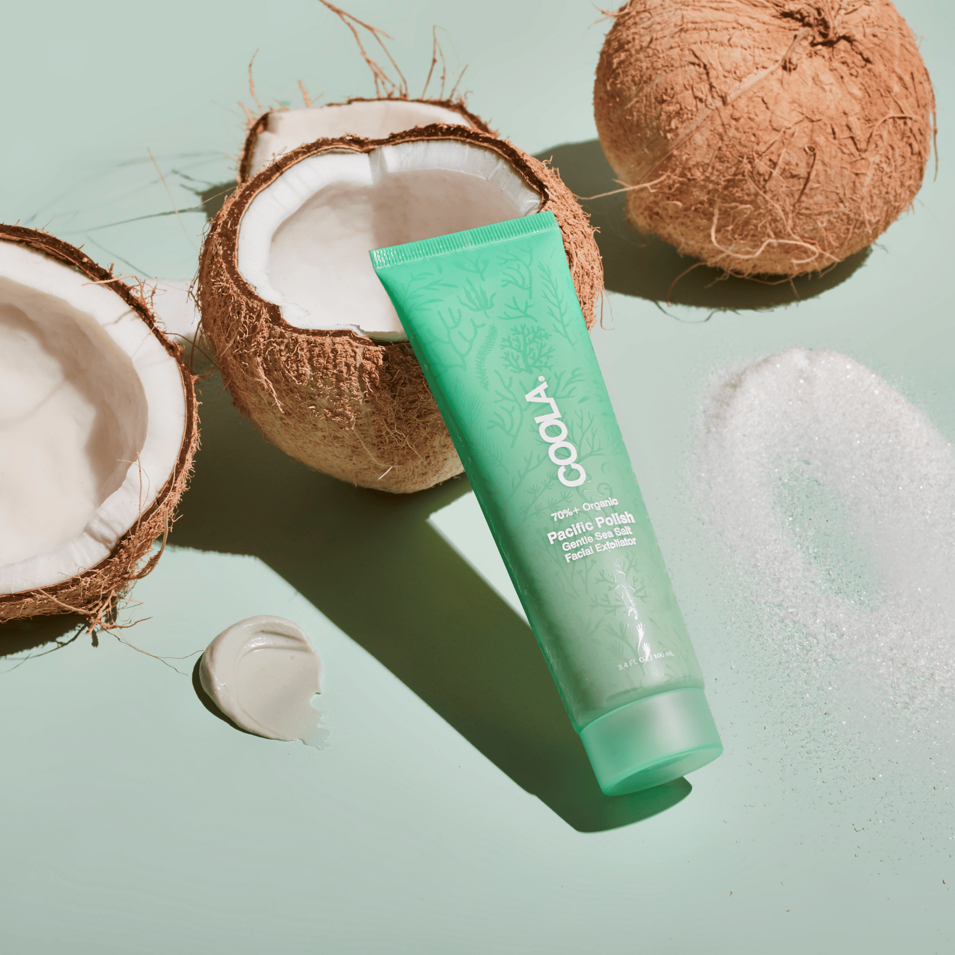 Coola Pacific Polish gentle sea salt facial exfoliator in a jar, showcasing its natural ingredients and textured surface.