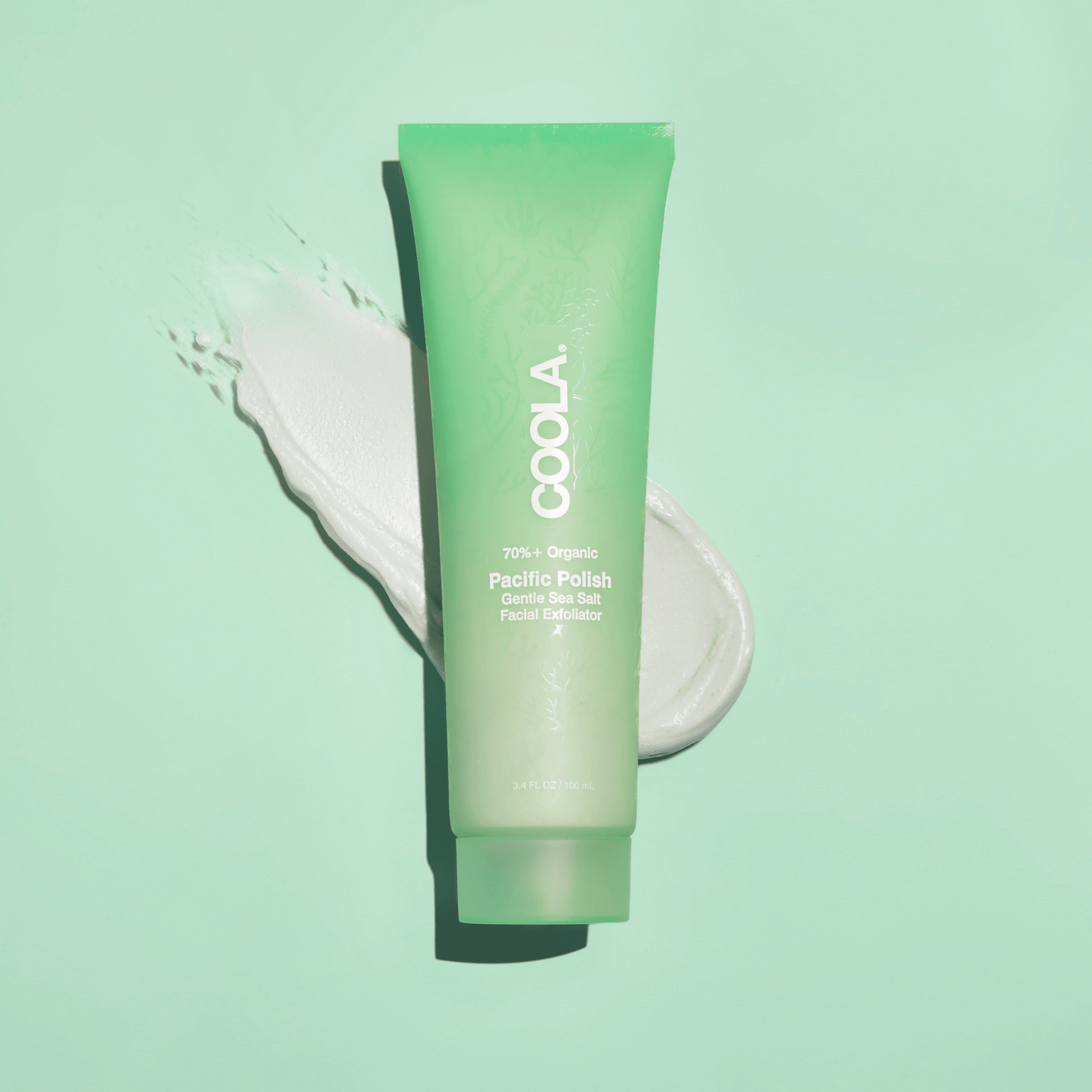 Coola Pacific Polish gentle sea salt facial exfoliator in a jar, showcasing natural ingredients and texture for smooth skin.