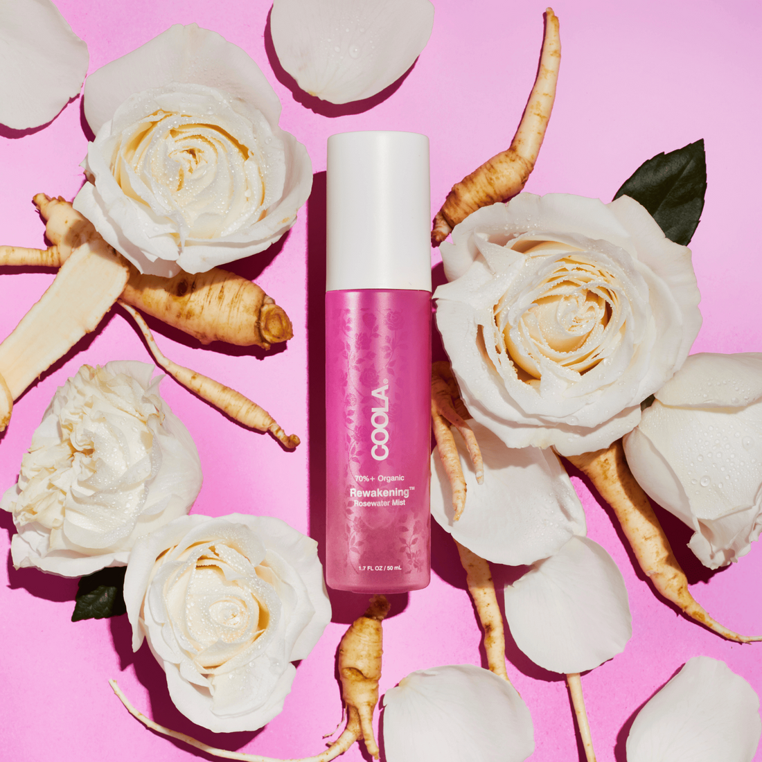 Coola Reawakening Rosewater Mist face spray in a clear bottle with a spray nozzle, featuring a rose-themed label for skincare.