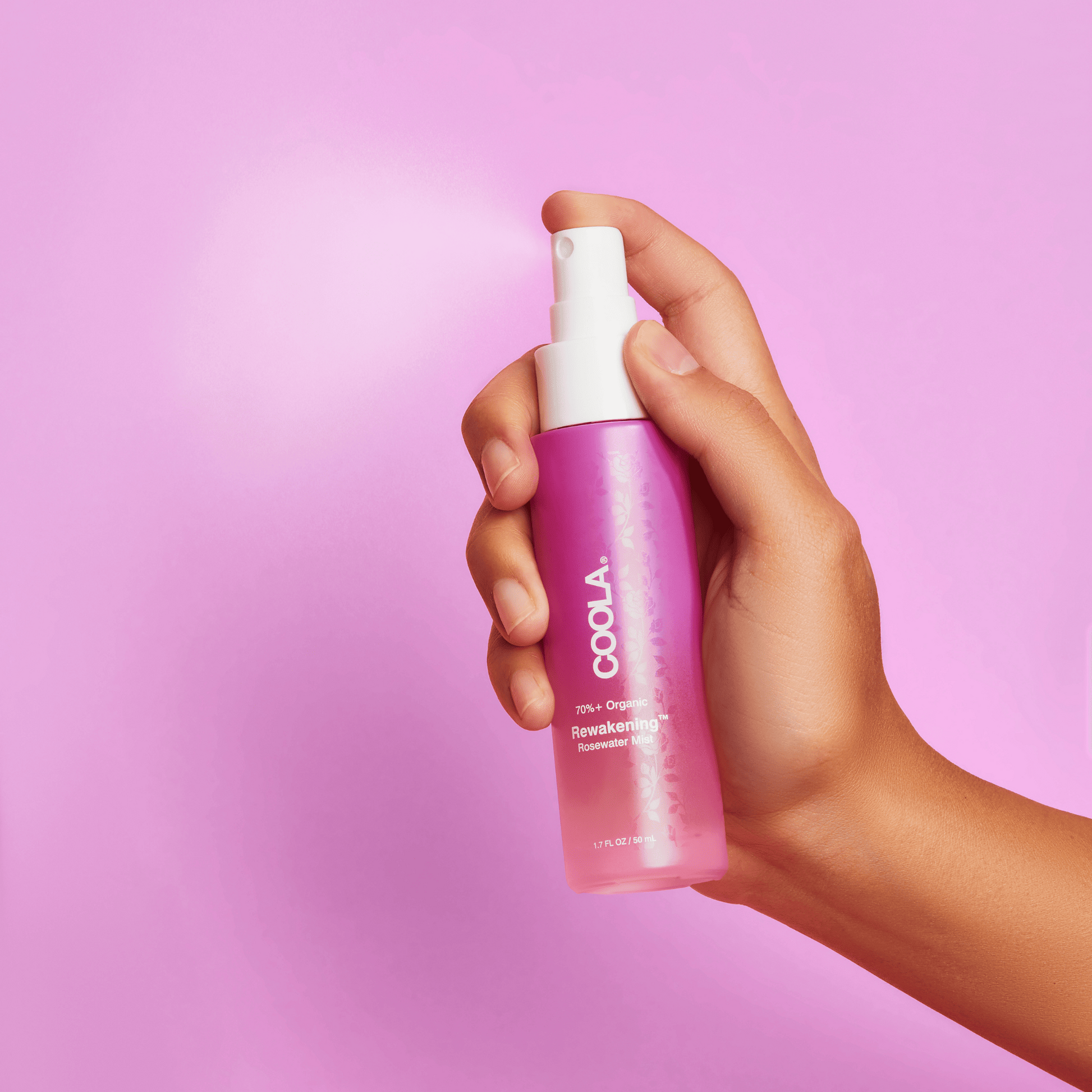 Coola Reawakening Rosewater Mist face spray in a clear spray bottle, designed for refreshing and hydrating skincare.