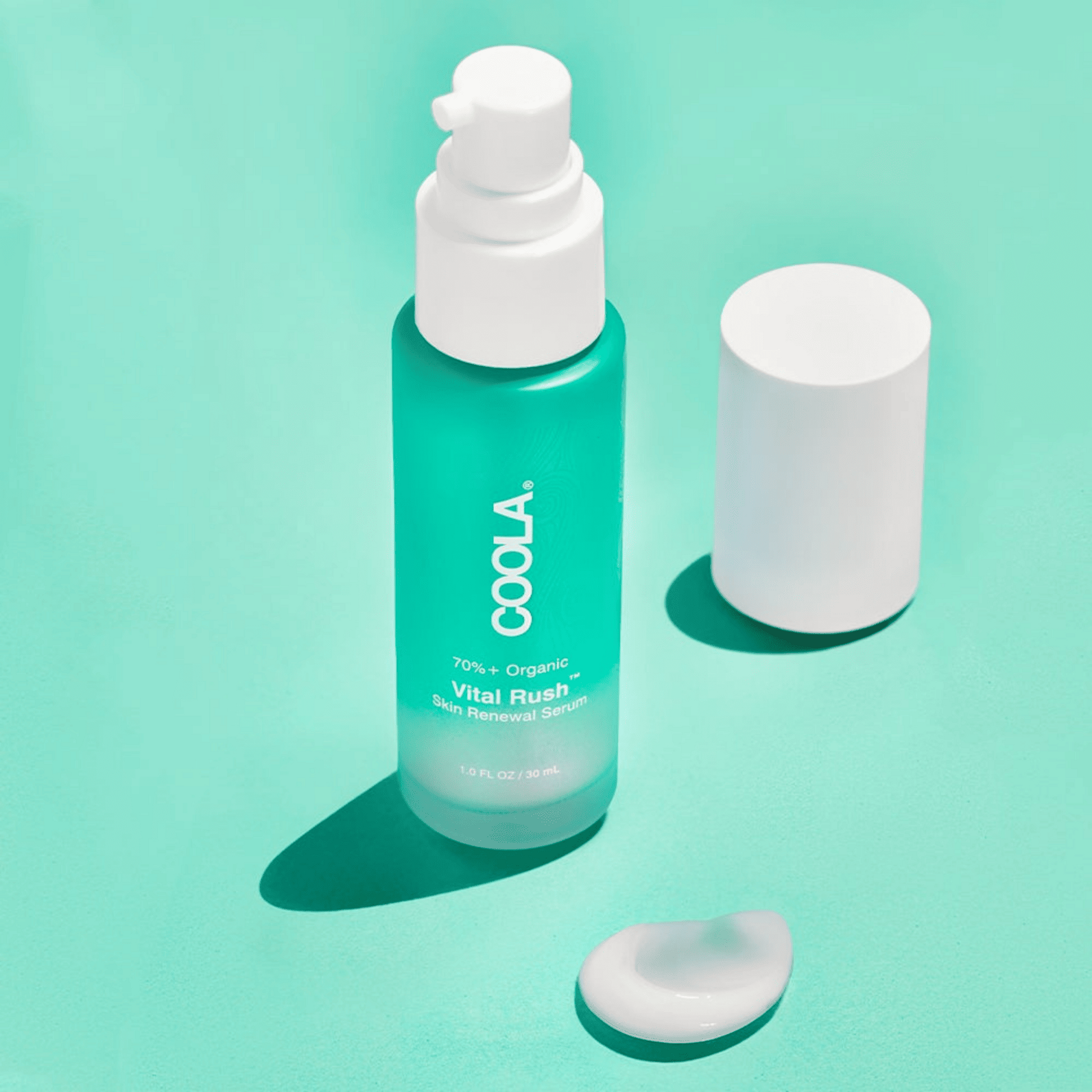 Coola Vital Rush Skin Renewal Serum in a clear glass bottle with a pump dispenser, showcasing its skincare serum formulation.