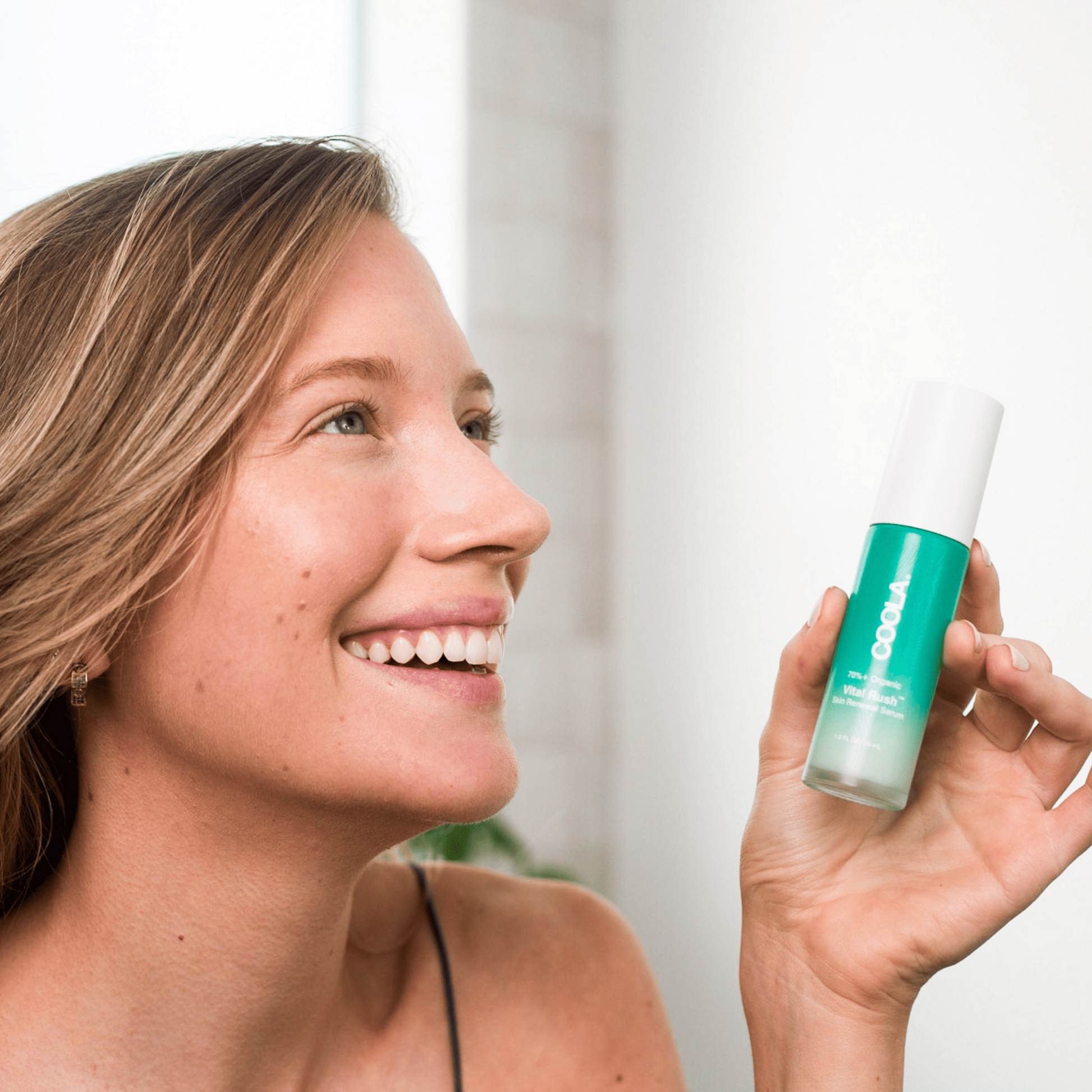 Coola Vital Rush Skin Renewal Serum in a clear glass bottle with a pump, showing the skincare serum for radiant skin.