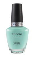 Cuccio Colour nail polishes featuring vibrant colors inspired by NYC, displayed in a row with bottles arranged on a white background.